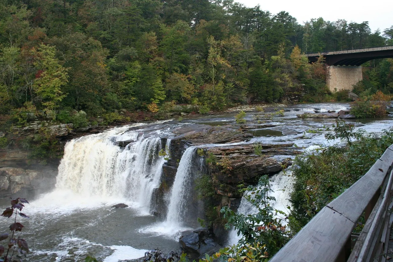 Little River Falls in autumn, seen from the boardwalk, with the Highway 35 bridge behind
