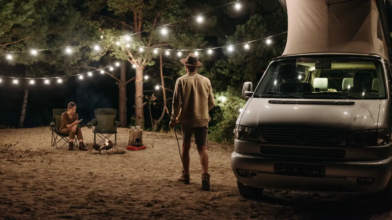 A couple by a small campfire at night, one carrying a roasting stick